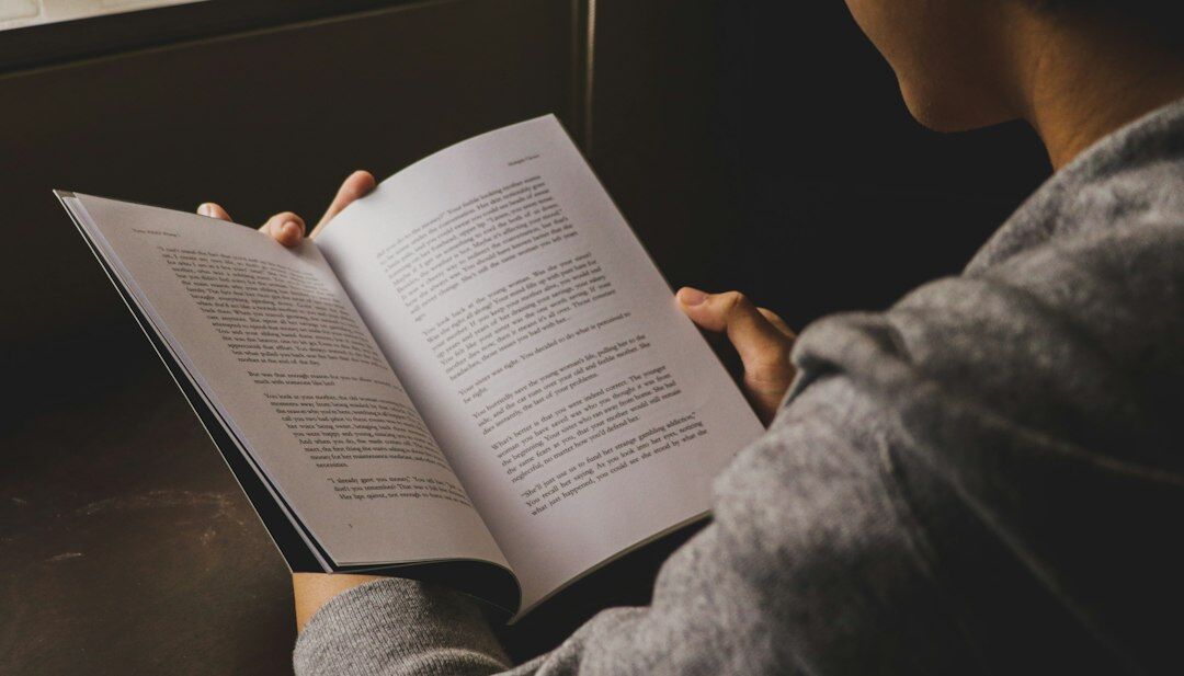 person reading book at night