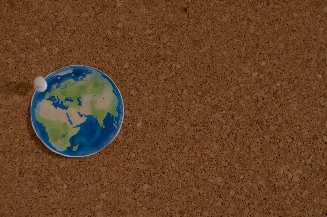Detective case notes with a magnifying glass and map pins on a cork board