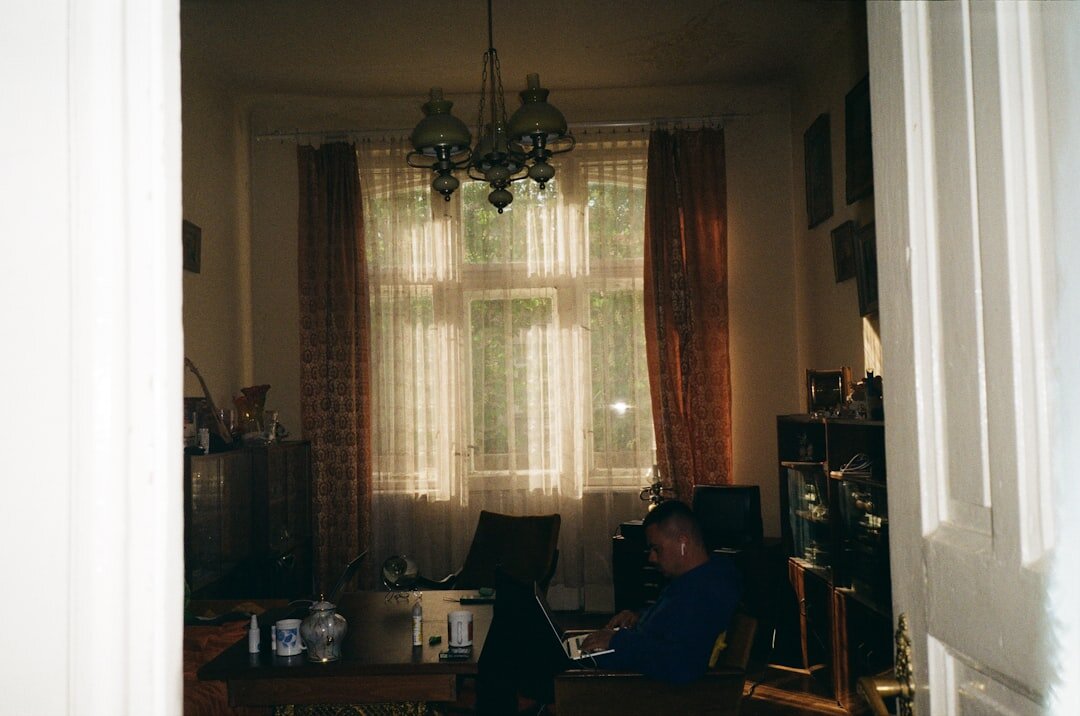 Portrait of a Croatian mystery writer sitting at a wooden desk