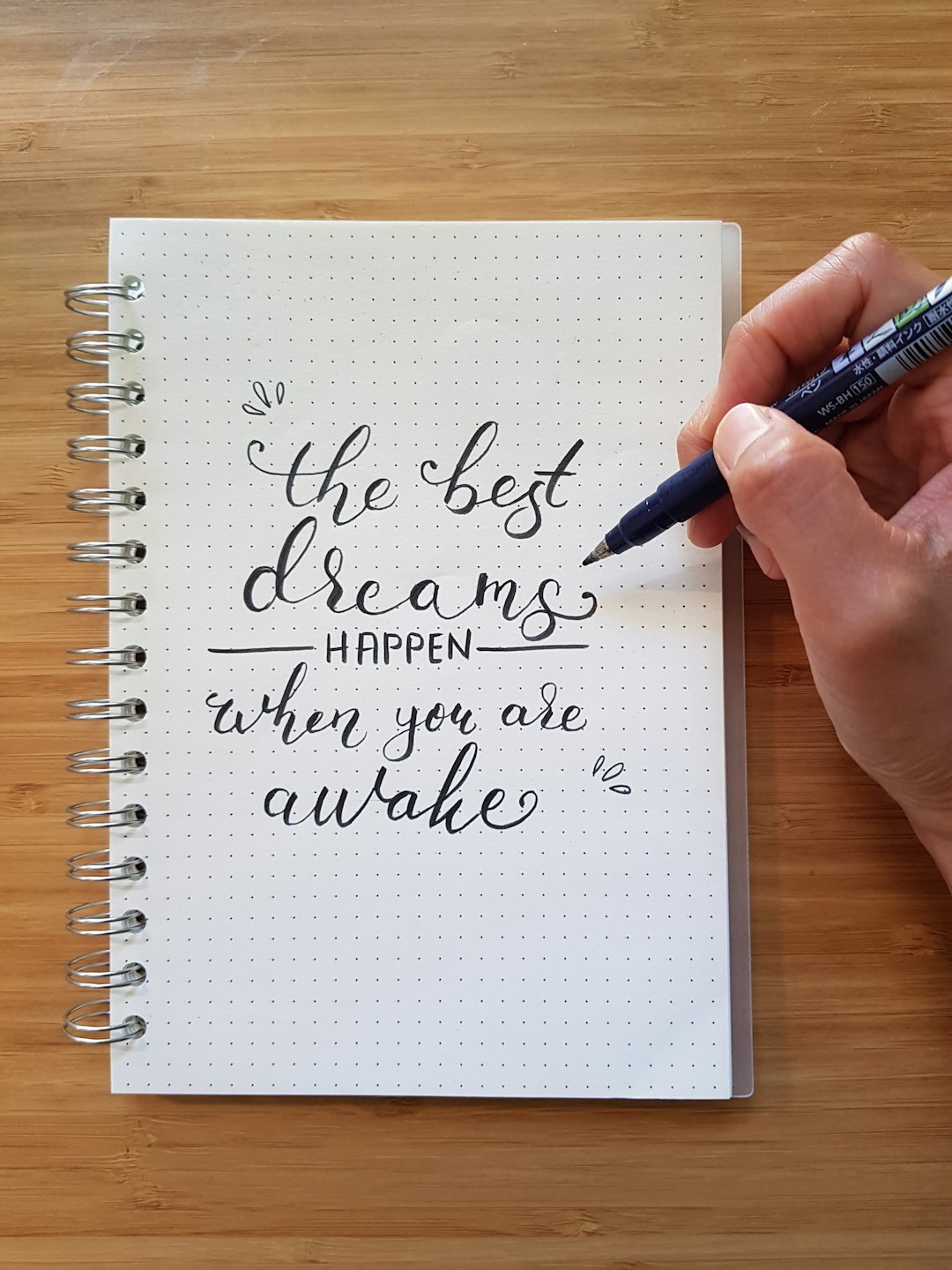 Close-up of a hand writing with a fountain pen in a notebook
